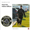 Book Cover showing a K9 Unit badge and a picture of a police officer and police dog walking on grass beside a parking lot.
